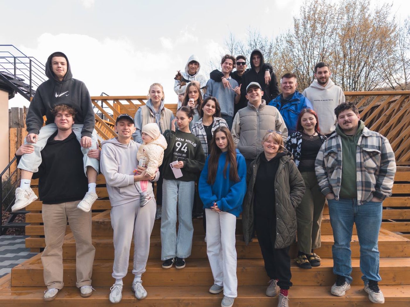 One Way young people on wooden stairs during a retreat
