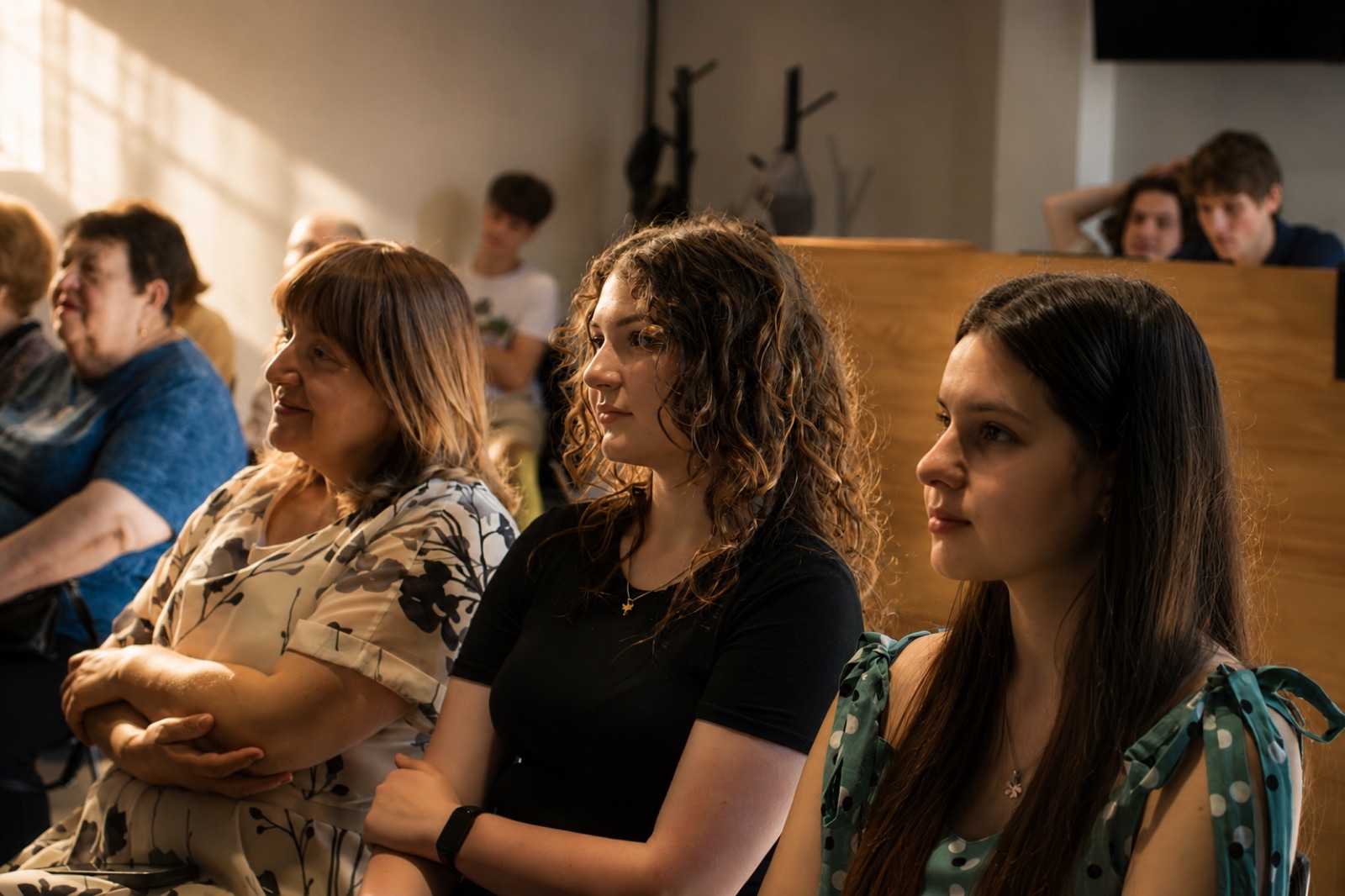 Women of different ages listening in the church hall